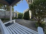 The front of the home is shaded by trees that offer privacy in the busy downtown area